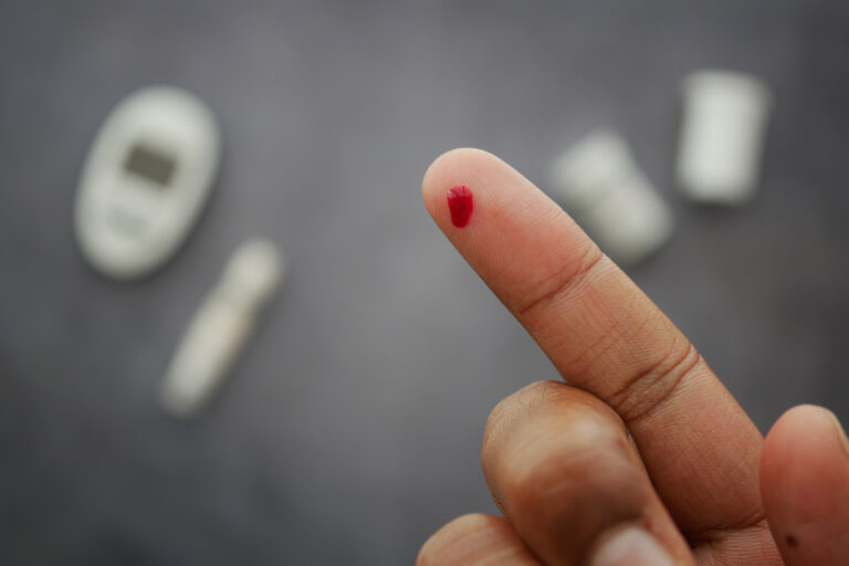 Blood sample on finger for diabetes testing at home