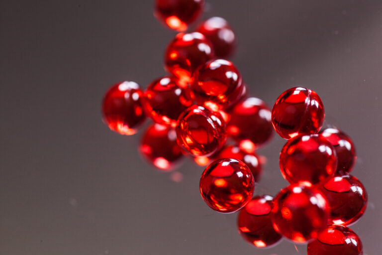 red capsules on mirror background